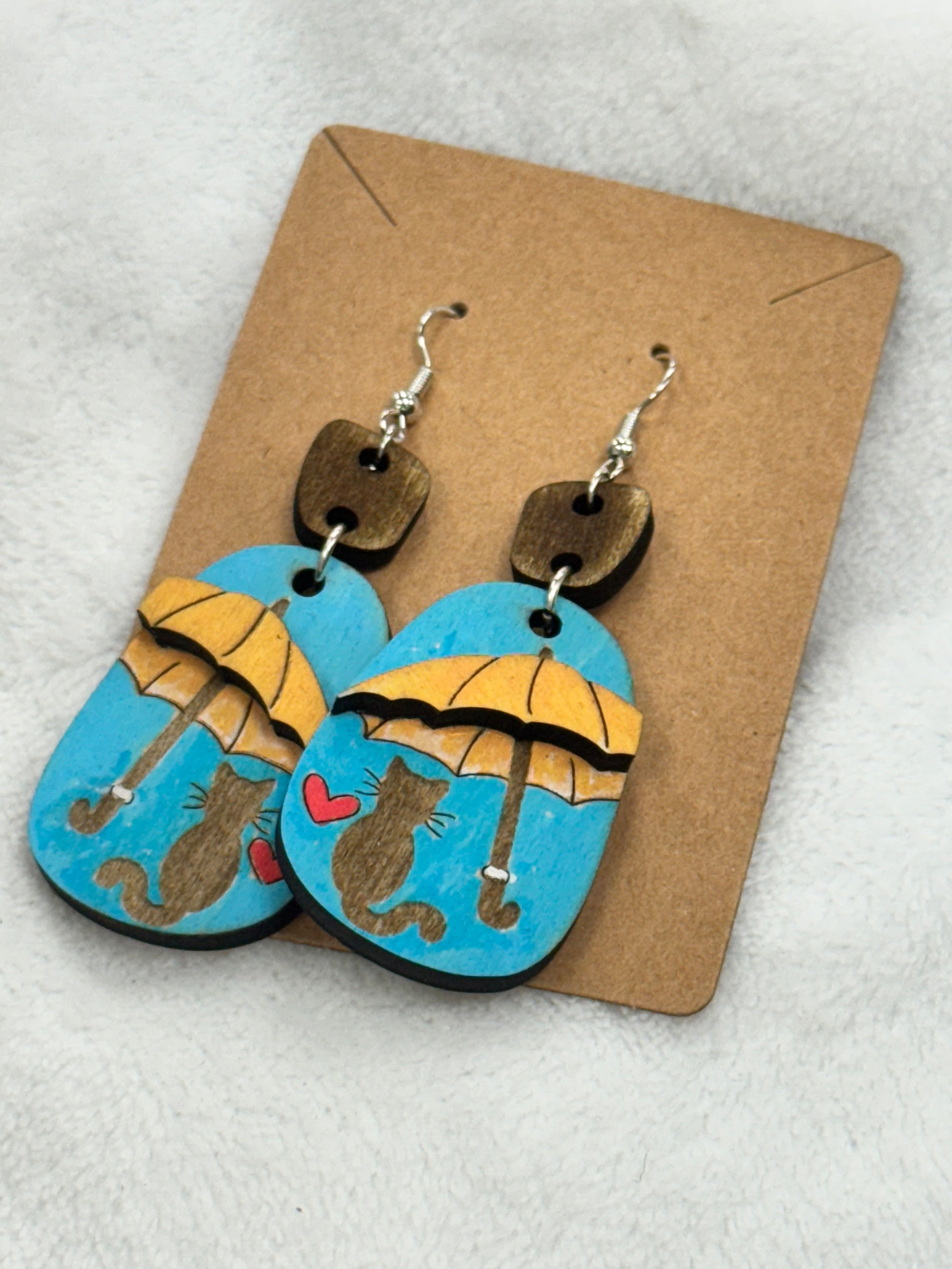 Handpainted Cat sitting under an Umbrella